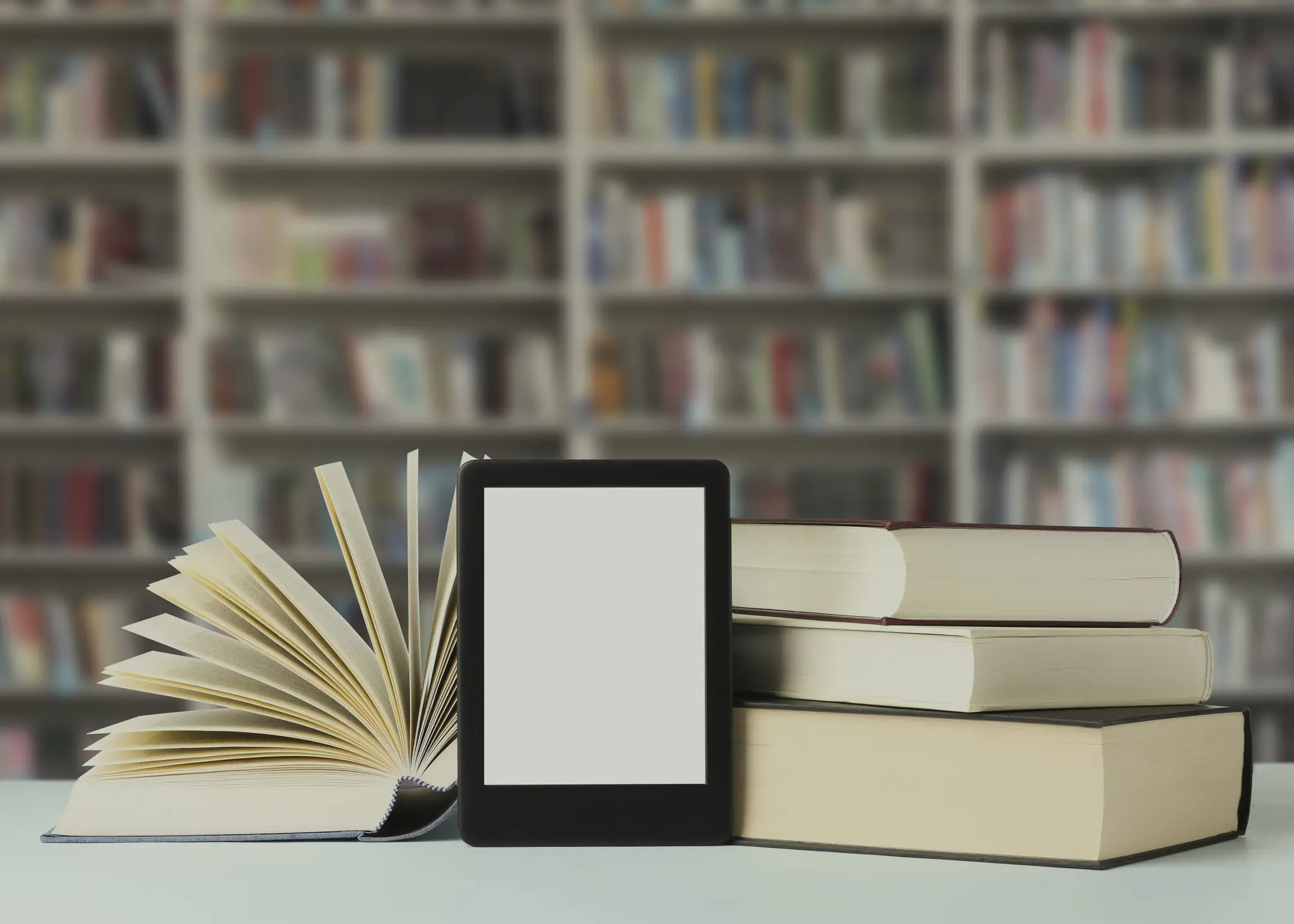 E-reader with open books in library